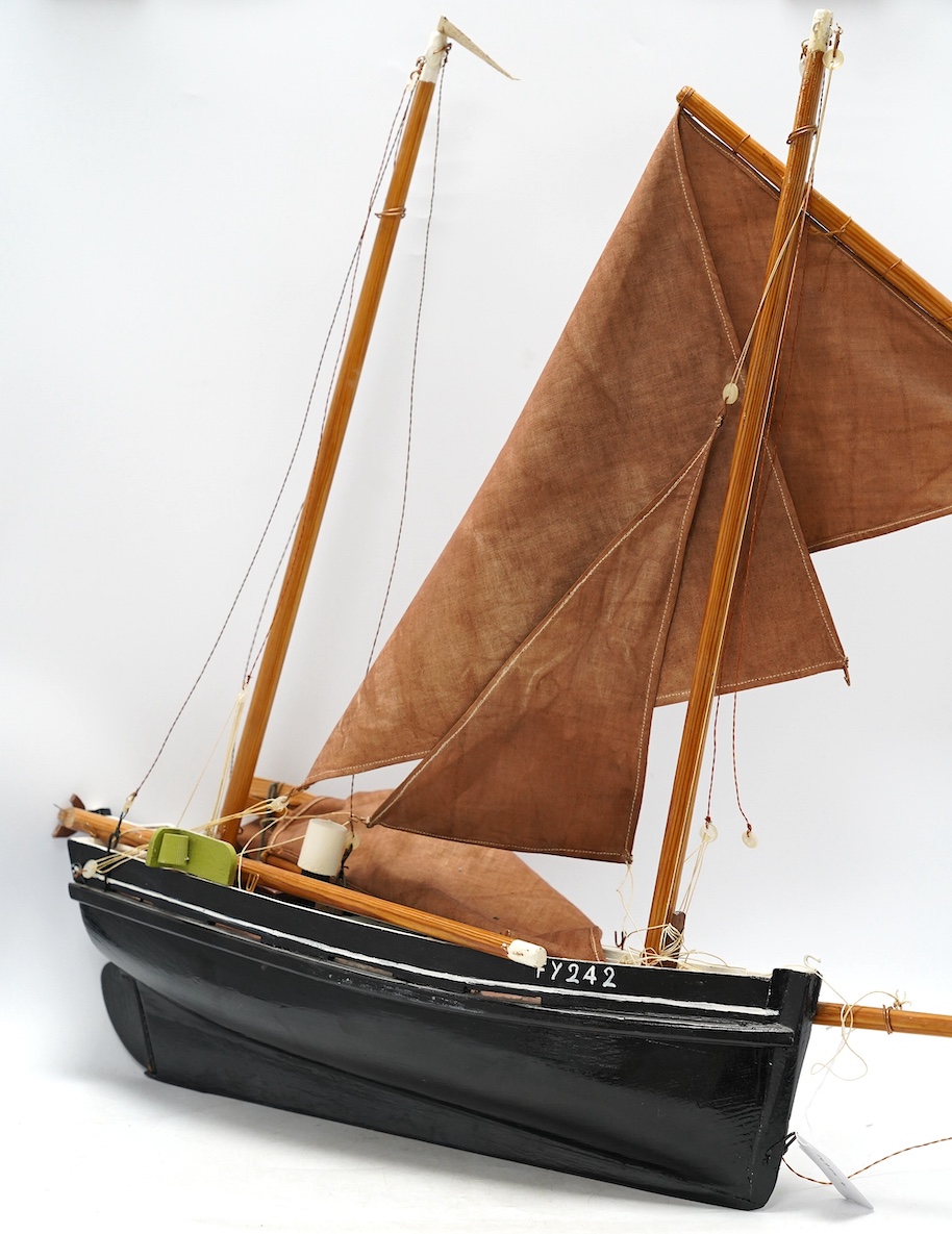 A painted wood pond yacht, 77cm in length. Condition - one mast broken